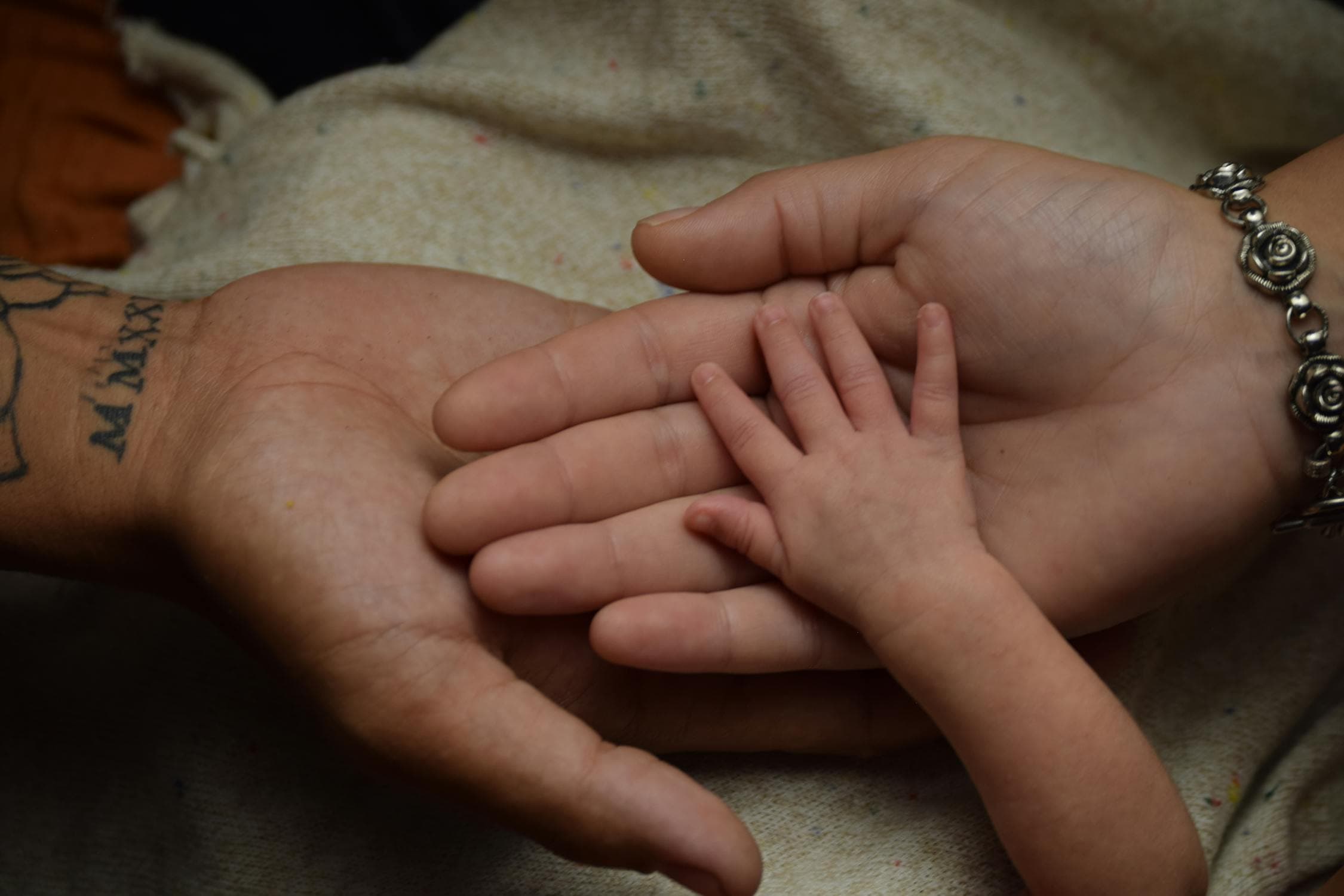 Three generations of hands held together